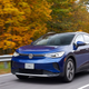 A blue Volkswagen ID.4 electric car driving down a road